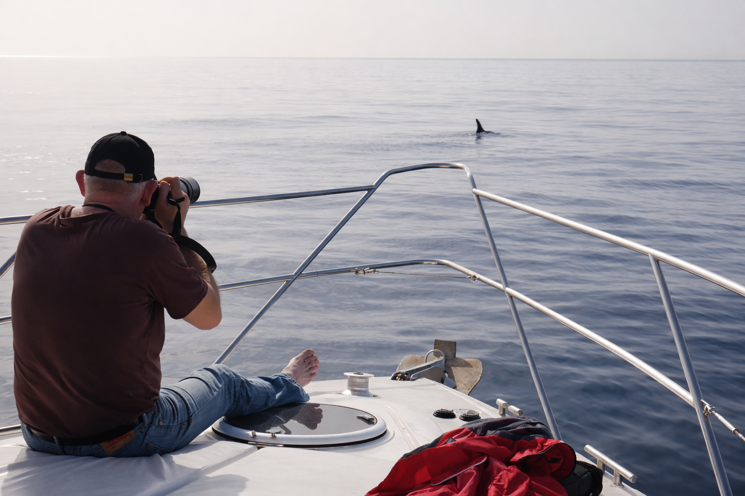 Man photographing dolphins from a boat during a dolphin watching trip in Gran Canaria